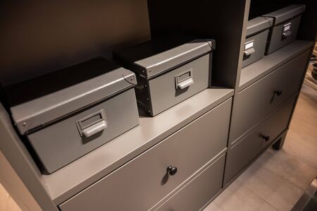 Closeup of a gray chest of drawers. A variant of simple furniture without decor and design in the interior.の写真素材