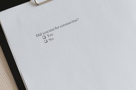 Coronavirus test questionnaire and pen on the table. Checklist for questions about covid-19.の写真素材