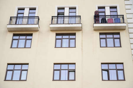 Direct view of the facade of a modern apartment building with balconies