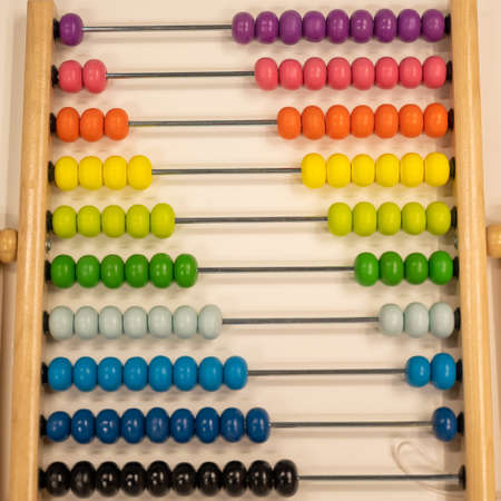 Bright colored hand abacus. Childrens wooden toy for the study of arithmetic.