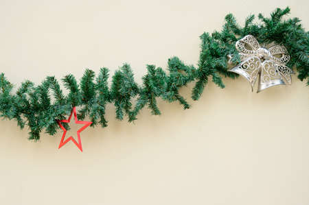 Christmas decoration. Garland with green spruce branches ana a white wall.の写真素材