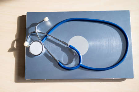 Top view of a stethoscope on a laptop. Doctors desk.