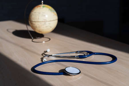 Globe and stethoscope. The concept of global warming and pollution. Phonendoscope and earth...