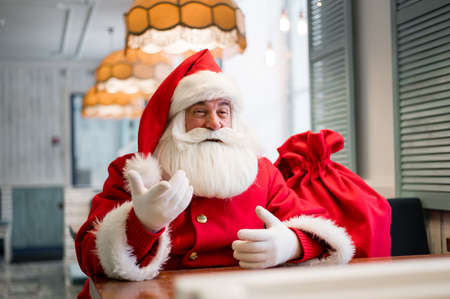 Friendly santa claus in a cafe.の写真素材