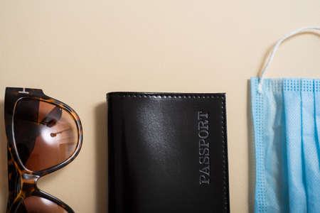Top view of the passport with a medical mask and sunglassesの写真素材