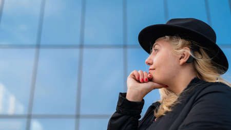 Portrait of a blonde woman wearing a Hearing Aidの写真素材