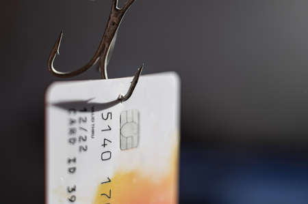 Close-up of a credit card on a fishing hook