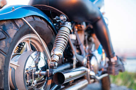 A woman in leather leggings is sitting on a motorcycle.の写真素材