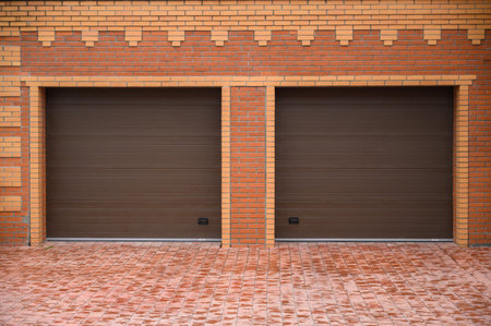 Double garage doors jalousie on red brick wallの写真素材