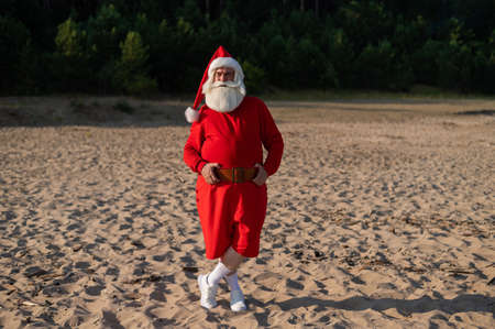 Santa claus posing by the sea. Christmas in a hot countryの写真素材
