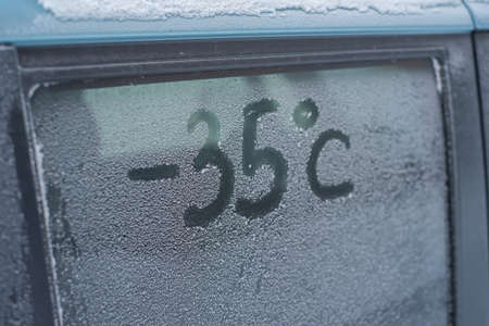 Inscription minus 35 degrees Celsius on a snow-covered car windowの写真素材