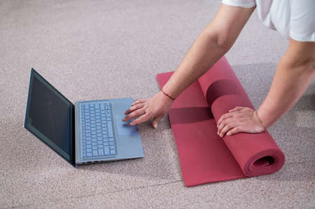 Young chubby woman preparing for an online fitness class. Distance training during the quarantine periodの写真素材