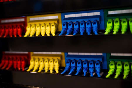 Multi-colored rows of network cables are connected to the system