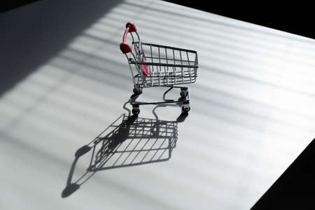 Shopping trolley on white table.の写真素材
