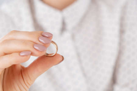 Faceless caucasian woman holding a wedding ring.の写真素材
