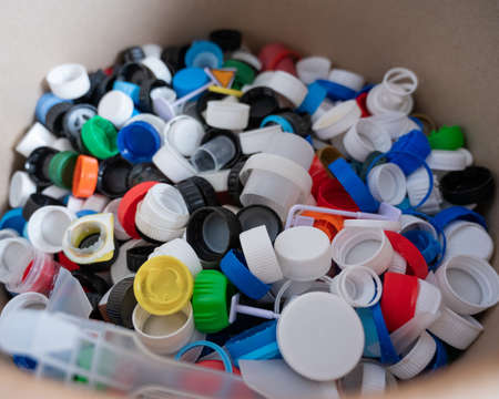 A close-up of many plastic bottle caps collected for recycling.の写真素材