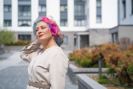 Close-up portrait of curly Caucasian woman with multi-colored hair. Model for hairstylesの写真素材