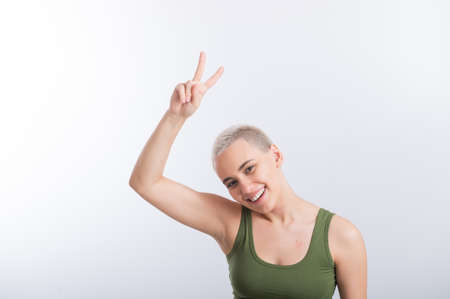 Young Caucasian Woman Holding Raised Hand White Background Smiling Girl Green Tshirt Short Blond...