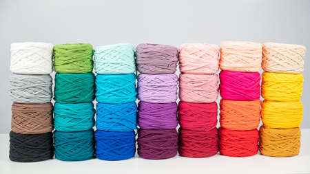 Rows of multicolored cotton yarn. The assortment of the store for needlework.