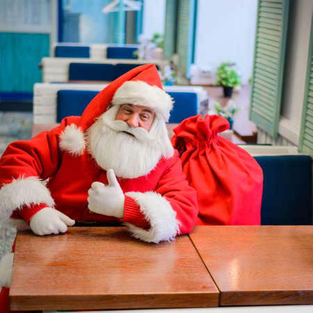 Friendly santa claus in a cafe.の写真素材