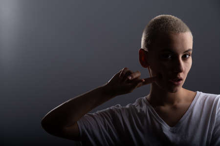 Portrait of pensive young woman with short hair on white background. Copy space