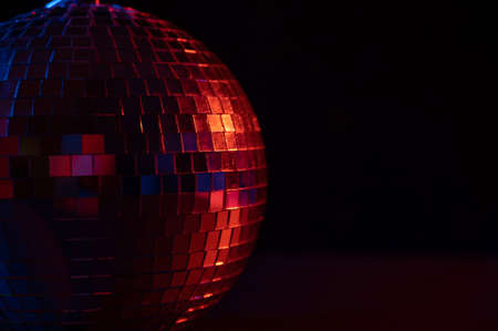 The disco ball is spinning in pink-blue smoke. Night life.の写真素材