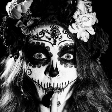 Woman in santa muerte makeup on a black background. Girl wearing traditional mexican holy death costume for halloween. Monochromeの写真素材