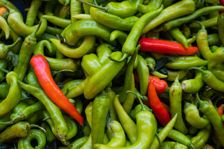 Close-up on a shelf with green and red peppers in the market.の写真素材