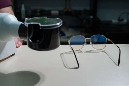 The optician fixes the frames of the glasses.の写真素材