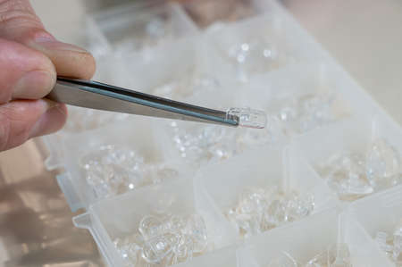 Installation of nose pads in glasses. A male technician repairs broken glassesの写真素材