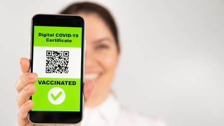 Woman showing smartphone with qr code about vaccination.の写真素材