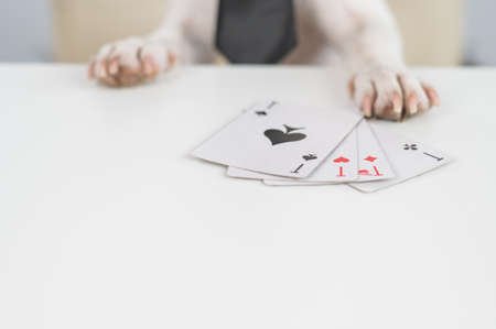 Jack russell terrier dog with glasses and tie plays poker. Addiction to gambling card games.