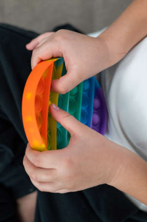 Faceless little boy playing rainbow colors.の写真素材