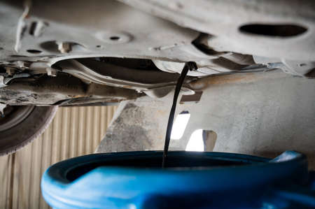 Change of old oil in a car engine.