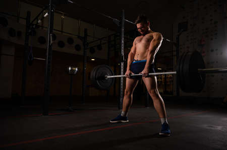 Shirtless caucasian man doing deadlift in the gym.の写真素材