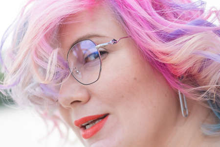 Close-up portrait of curly Caucasian woman with multi-colored hair. Model for hairstyles