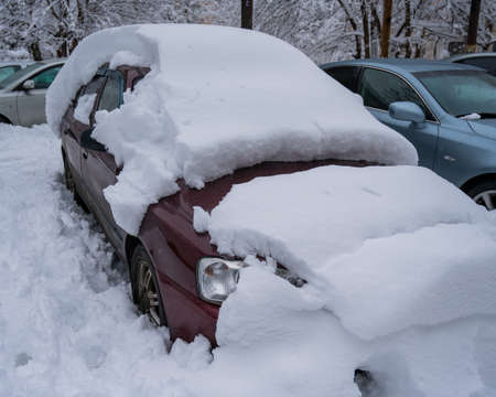 Car under a big snowdrift in winter.の写真素材