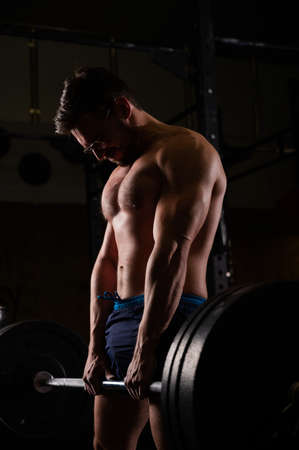 Shirtless caucasian man doing deadlift in the gym.の写真素材