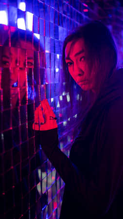 Portrait of a male transgender model in neon light.