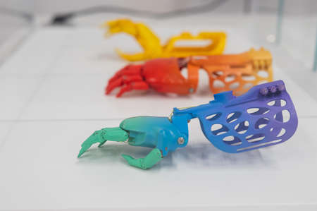 Samples of multi-colored childrens prosthetic hands made of 3D plastic.の写真素材