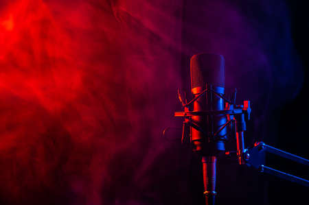 Professional microphone in pink smoke on a black background.の写真素材