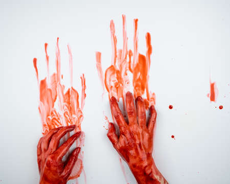 Female hands in blood on a white background.の写真素材