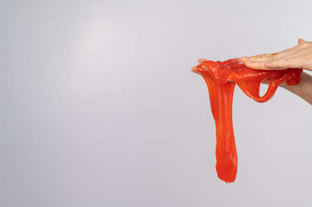 Red slime flowing down from a womans hand on a white background.の写真素材