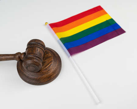 Judge gavel and hand lgbt flag isolated on white background.の写真素材