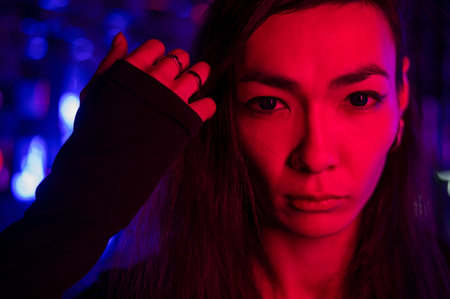 Portrait of a male transgender model in neon light.
