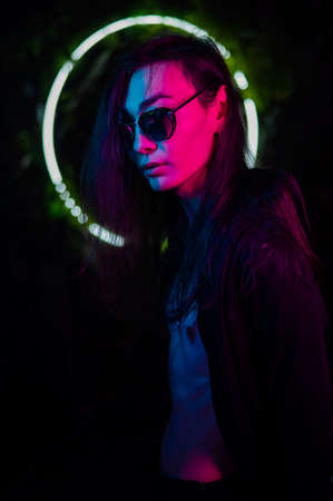Portrait of asian man wearing sunglasses in neon light.