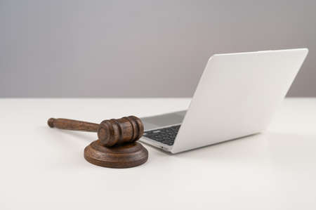 Judicial gavel and laptop on white background.の写真素材