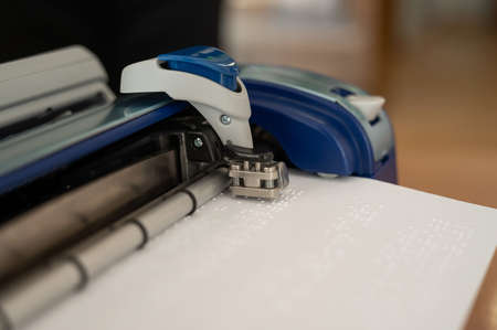 Close-up of a braille code printing machine.