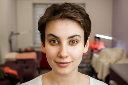 Caucasian woman before procedure in beauty salon.
