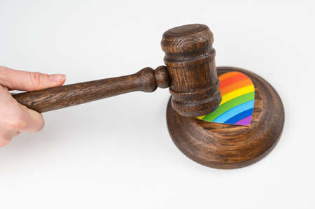 The judge hits a heart with a rainbow flag with a gavel.の写真素材